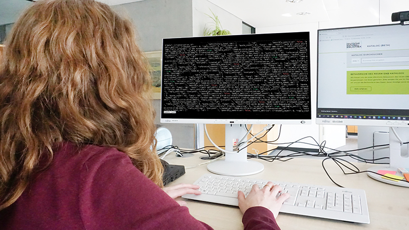 One person is looking at a web code on a screen. One person is looking at a web code on a screen.